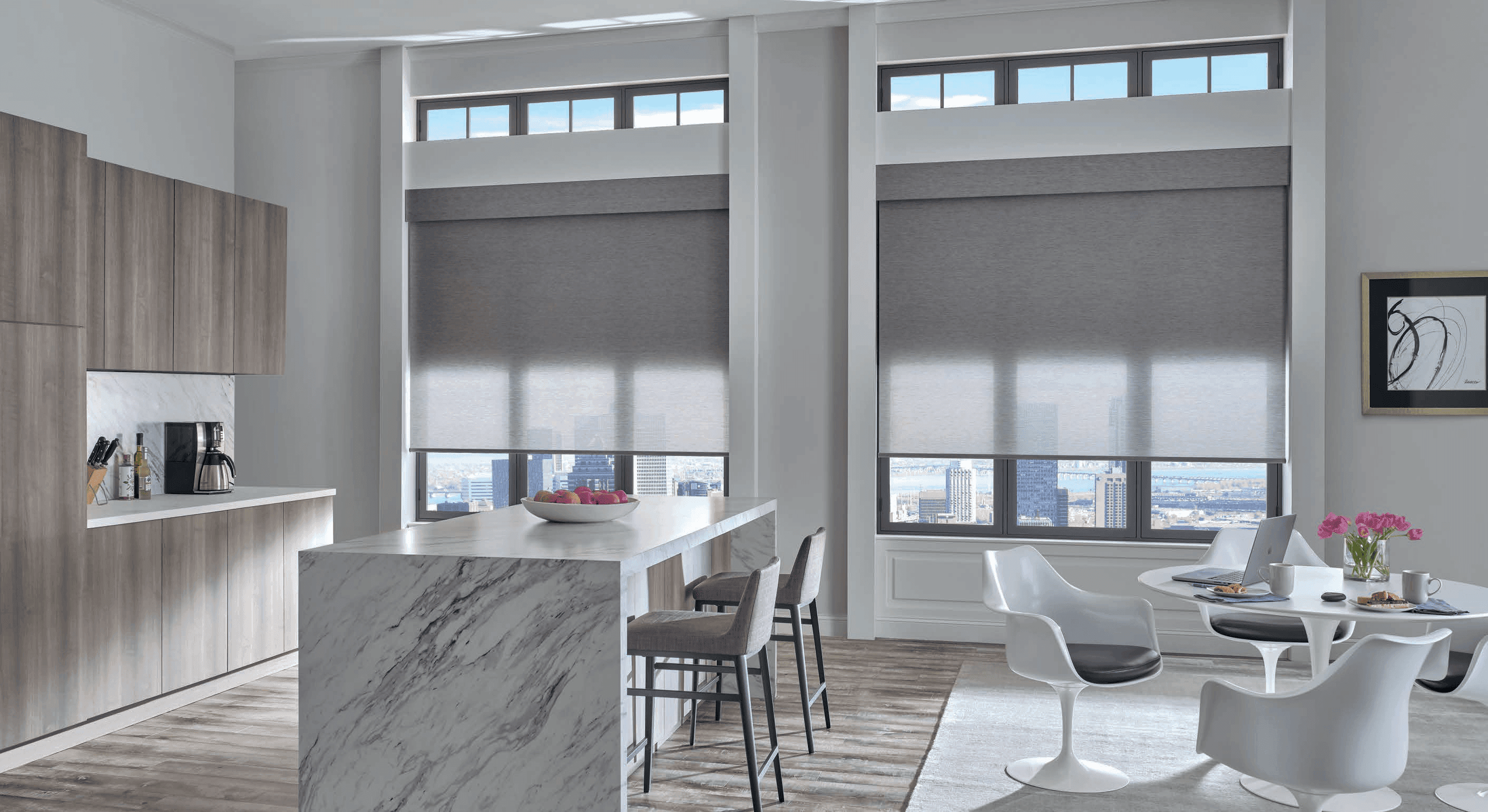 Grey screen shades on large kitchen windows overlooking the city