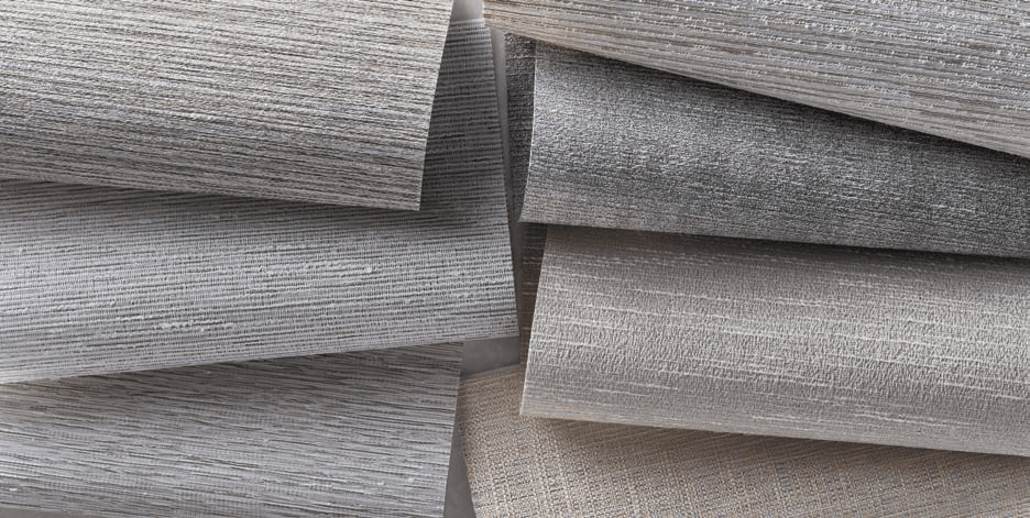 Layered roller shade fabric samples in neutral woven textures