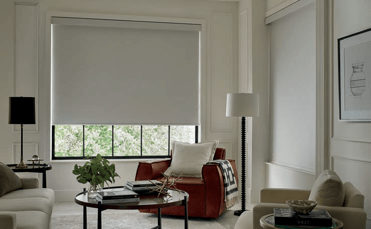 Lowered roller shades in a softly lit living room