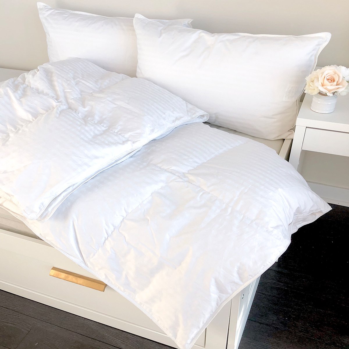 White Prima Ultra Down Duvet with damask stripes on a bed